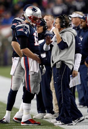 New England Patriots quarterback Tom Brady, left, talks with head coach Bill Belichick during the second half of an AFC divisional playoff NFL football game against the Houston Texans in Foxborough, Mass., on Jan. 13, 2013. The Patriots defeated the Texans 41-28. (