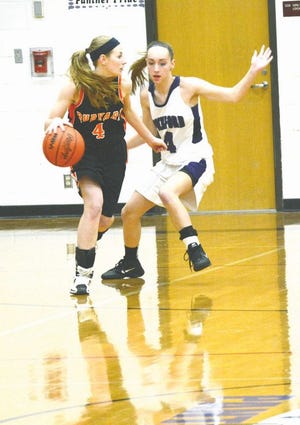 Rudyard’s Marissa Harrison (4) tries to get to the basket while Pickford’s Alyssa McCord defends during Tuesday night’s girls basketball game.