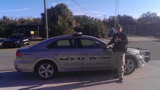 Tybee Island police Sgt. Emory Randolph stands next to one of two turbo diesel Volkswagen Passat patrol cars the department purchased. (Photo courtesy Tybee Island Police Chief Bob Bryson)