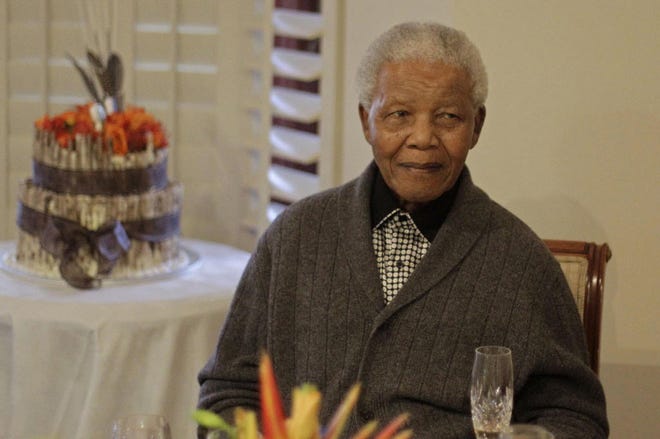 In this Wednesday, July 18, 2012 file photo, former South African President Nelson Mandela as he celebrates his 94th birthday with family in Qunu, South Africa. Mandela died today at age 95.