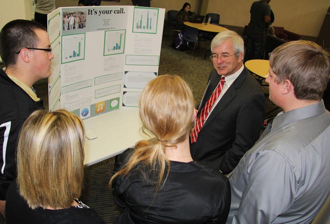 Monmouth College President Mauri Ditzler meets with Carl Sandburg College students following the signing at an academic poster session, showcasing their research projects. COURTESY PHOTO