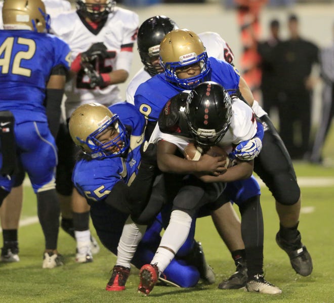 Mainland's Kailik Williams and Phillip Haire take down a South Fort Myers player last week.