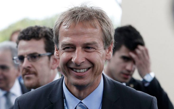 United States head coach Juergen Klinsmann from Germany smiles as he arrives for the draw ceremony for the 2014 soccer World Cup in Costa do Sauipe near Salvador, Brazil, Friday, Dec. 6, 2013.