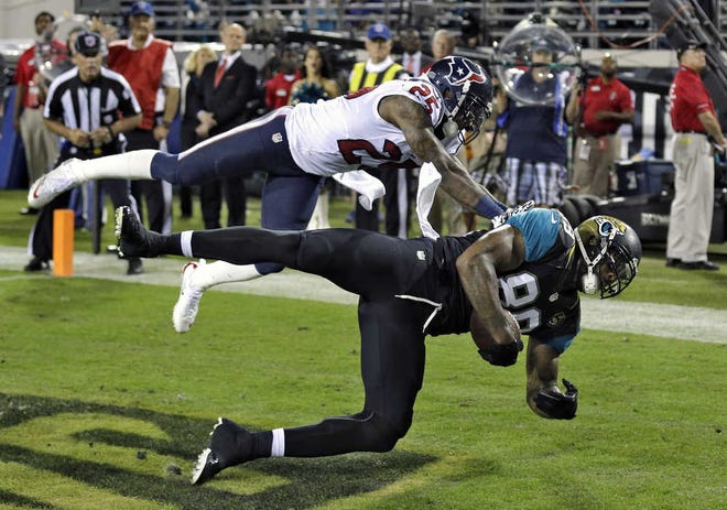 Jacksonville Jaguars tight end Marcedes Lewis (89) pulls in a one-yard touchdown reception in front of Houston Texans cornerback Kareem Jackson (25) during the first quarter of an NFL football game Thursday, Dec. 5, 2013, in Jacksonville, Fla. (AP Photo/Chris O'Meara)
