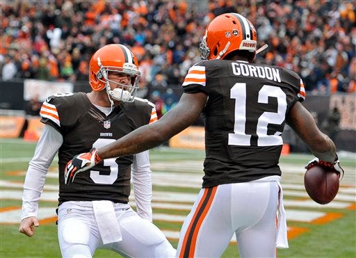 Cleveland Browns quarterback Brandon Weeden (3) celebrates with wide receiver Josh Gordon (12) after they connected on a 21-yard touchdown pass against the Jacksonville Jaguars in the second quarter of an NFL football game on Sunday, Dec. 1, 2013, in Cleveland.