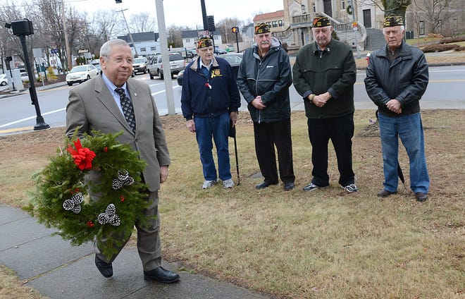 State Sen. Richard Moore, D-Uxbridge, prepares to lay a wreath at the World War I memorial in Calzone Park in Milford as (from left) William Porter, Larry Hughes, Steve Petak and Paul Lavallee of the Milford Veterans of Foreign Wars Post 1544 look on Friday. The wreath-laying was part of the Wreaths Across America program.