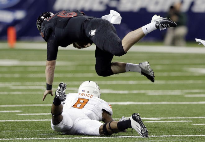 Northern Illinois quarterback Jordan Lynch gets upended by Bowling Green defensive back Cameron Truss (8) during the first half of the Mid-American Conference championship game Friday in Detroit. The Huskies lost 47-27.