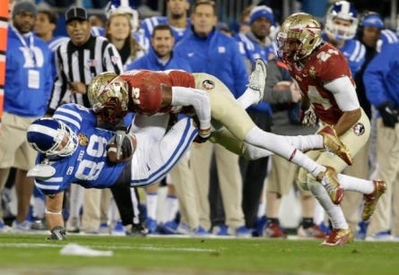 Duke's Braxton Deaver (89) is hit by Florida State's Jalen Ramsey (13) in the first half of the ACC football title game