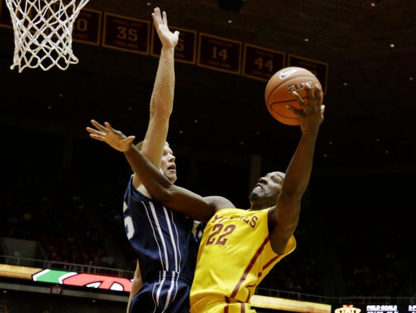 Iowa State's Dustin Hogue (right) drives to the basket past UNCW's Luke Hager during their game Nov. 10 in Ames, Iowa. The Seahawks saw how the other half lives in trips to major-conference foes Iowa and Iowa State early this season. Associated Press file photo