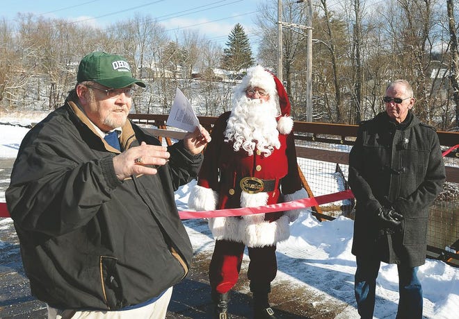 Dennison Mayor Tim Still (left) thanks contributors to the Panhandle Passage Trail project during Saturday's ribbon-cutting ceremony for the bridge, along with Santa Claus and Uhrichsville Mayor Terry Culbertson.