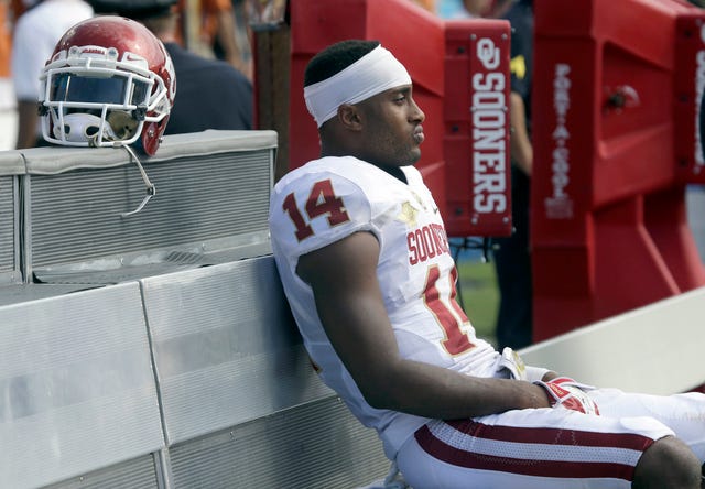 Associated Press File Photo  Oklahoma defensive back Aaron Colvin sits on the bench and watches the final minute of the Sooners' 36-20 loss to Texas on Saturday, Oct. 12,2013, at the Cotton Bowl in Dallas.