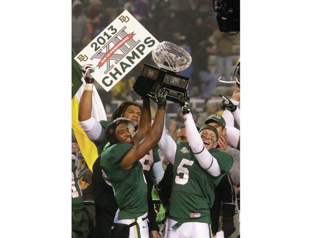 Baylor safety Ahmad Dixon, left, and linebacker Eddie Lackey (5) lift the Big 12 trophy after their NCAA college football game against Texas Saturday, Dec. 7, 2013, in Waco, Texas. Baylor won 30-10 to clinch the title. AP Photo/LM Otero