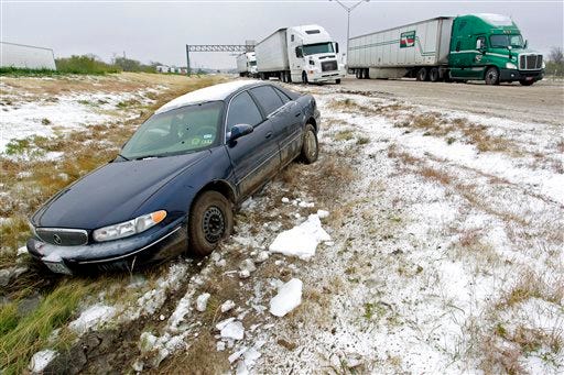 A car that slid off of the road sits abandoned on I-20 (westbound) near Winscott Rd. in Benbrook. Cold and ice remained in Fort Worth Sunday, Dec. 8, 2013, with roads especially treacherous in the the morning hours before temperatures rose.