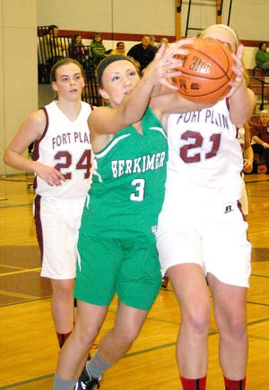 Herkimer’s Hannah DeLude and Fort Plain’s Bri Florian (21) pursue a loose rebound along the end line Saturday night. 



Times Photo/Jon Rathbun