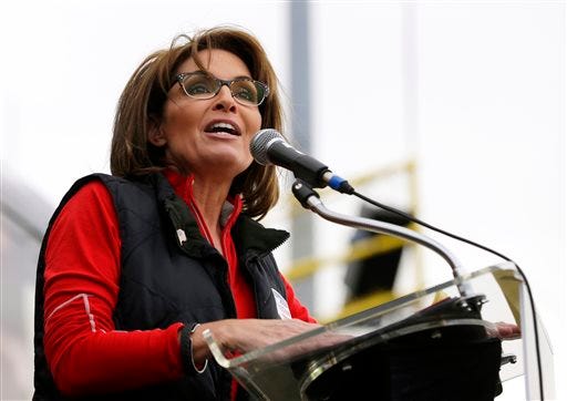 This Oct. 12, 2013 file photo shows former Alaska Gov. Sarah Palin during a rally supporting Steve Lonegan who is running for the vacant New Jersey seat in the U.S. Senate, in New Egypt, N.J. The Sportsman Channel said Monday it has hired Sarah Palin to be host of a weekly outdoors-oriented program that will celebrate the "red, wild and blue" lifestyle. The program, "Amazing America," will debut next April.