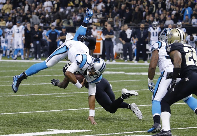 Panthers quarterback Cam Newton is upended as he carries against Saints free safety Malcolm Jenkins in Sunday’s Panthers’ loss in New Orleans.