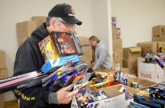 Robert Falkingham, of Pekin, a member of the Central Illinois Leathernecks, balances an armload of toys Monday collected in the U. S. Marine Corps Reserve's Toys for Tots campaign. The Marines collected new, unwrapped toys for distribution to children by the Salvation Army.