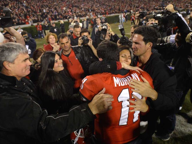 Georgia quarterback Aaron Murray (11) receives hugs and support from family members before Georgia takes on Kentucky at Sanford Stadium on Saturday, Nov. 23, 2013, in Athens, Ga.  (Richard Hamm/Staff) OnlineAthens / Athens Banner-Herald