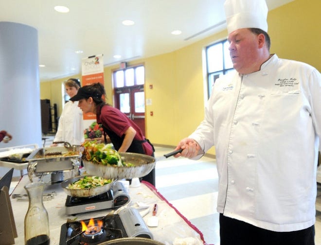 Chef Douglas Kulp of Chartwells School Dining Services tosses a vegetable stir-fry on Friday in the cafeteria of Stroudsburg Intermediate School in Stroud Township.