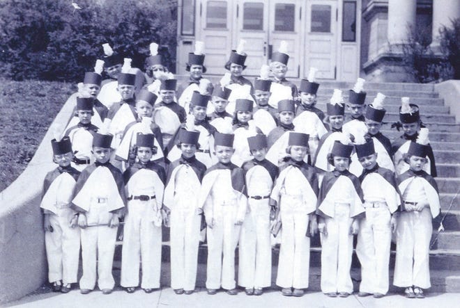A second-grade class from Central School lines up on the front steps of old Kewanee High School in 1936 dressed in the attire worn for music teacher Octavia Blair’s rhythm band.