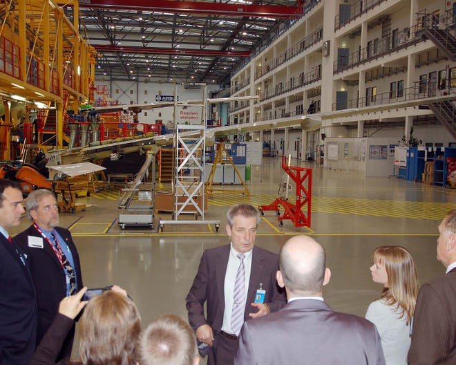 Airbus tour guide Gerd Rogge talks to the local delegation of business and community leaders about the Airbus final assembly facility in Hamburg, which finishes one A320 aircraft almost every two to three days.