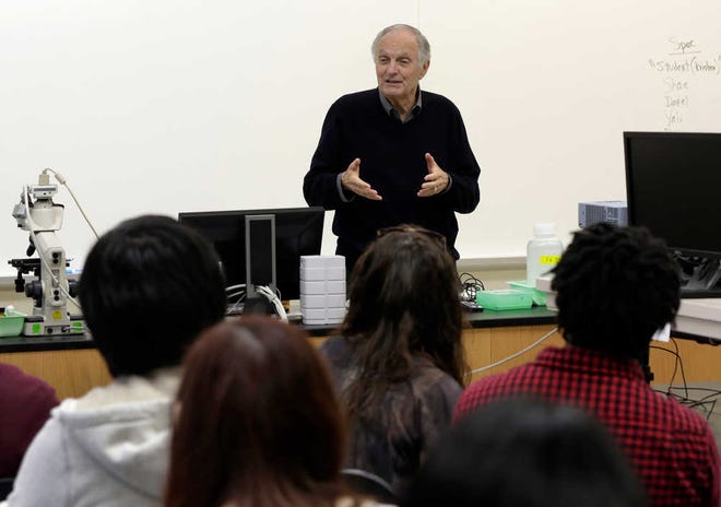 FILE - In this April 26, 2013 file photo, actor and sometimes science professor Alan Alda addresses a Communicating Science class on the campus of Stony Brook University, on New York's Long Island. Alan Alda is now posing the question "How do you explain color to an 11-year-old?," to scientists around the world. It's part of a contest he started three years ago called the "Flame Challenge," to encourage scientists to find better ways of clearly explaining how science works to the general public. (AP Photo/Richard Drew, File)