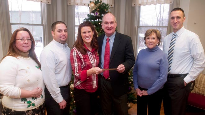 Dover Children's Home receives half of a $550,000 bequest from the estate of longtime resident Ron Newell, who died in August. From left are Dover Children's Home board members Paulette Rouleau, James Boos, Executive Director Donna Coraluzzo, presenter Mark Speidel, board members Bonnie Peterman and Dover Police Detective Mark Nadeau.