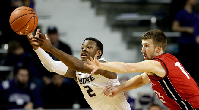 Kansas State's Marcus Foster, left, and the Wildcats held off Adam Thoseby and South Dakota on Tuesday night.