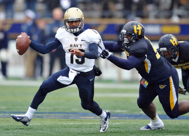 Toledo defensive tackle Treyvon Hester, right, chases Navy quarterback Keenan Reynolds on Oct. 19 in Toledo, Ohio. Reynolds has enjoyed a sensational sophomore season, running for 1,124 yards and 26 touchdowns.