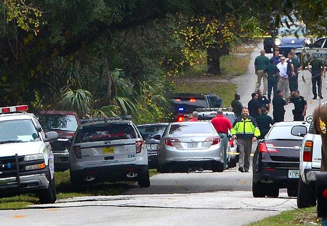 PHILLIP WHITLEY/CORROSPENDENT St. Johns County detectives and deputies block off Katnack Road at the scene of a shooting Wednesday afternoon, December 11, 2013.