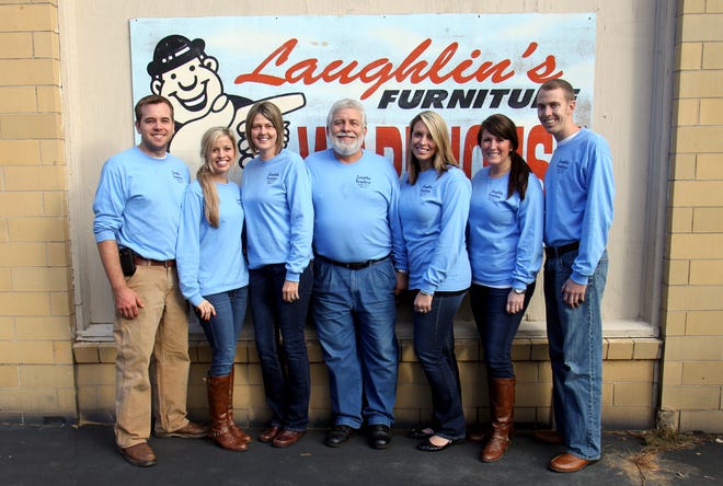 From left, Ben and Jennifer Cabaniss; Kim, owner John, Kimery, Sara and Charles Laughlin celebrate the 25th anniversary of Laughlin Furniture. Brittany Randolph/The Star