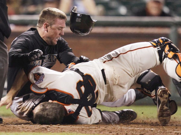 San Francisco catcher Buster Posey, right, breaks his leg in a collision at home plate with Miami's Scott Cousins on May 25, 2011. (Marcio Jose Sanchez | Associated Press)