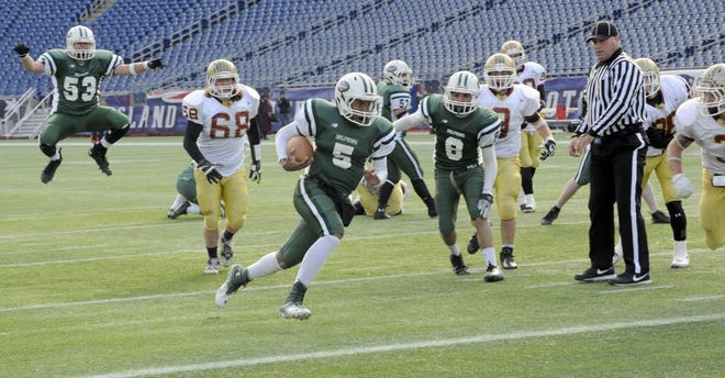 The new statewide football tournament was a hit with Dennis-Yarmouth. Spencer Tyler (5) and the Dolphins made it to the Super Bowl at Gillette Stadium – much to the delight of teammate Chase Orava (53). D-Y's bid for a state title came up short as it lost to Doherty High of Worcester, 28-26.