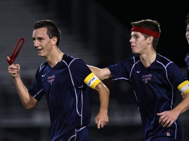 Vanguard's #5 Quinn Ciambella celebrates with teammate #22 Justin Taylor after Ciambella's goal against Forest High School. The Knights went on to win, 2-1, Friday night, December 13, 2013 at Forest High School in Ocala, Florida.