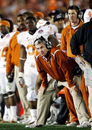 In this Jan. 7, 2010, file photo, Texas coach Mack Brown watches during the the fourth quarter of the BCS Championship NCAA college football game against Alabama in Pasadena, Calif. Brown has stepped down as coach and that the Alamo Bowl against Oregon on Dec. 30 will be his last game with the Longhorns, the school announced Saturday.