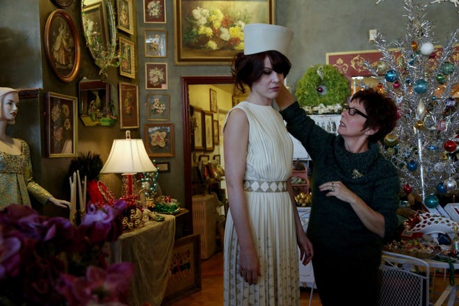 Wanda Soileau, right, owner of the vintage store, Playclothes, adjusts a hat on Seera Wright, who works in the store, as she tries on clothing that belonged to actress Edie Adams. The store recently held a fashion show that featured clothing belonging to the 1960s actress. The store supplies clothes and other props to “Mad Men,” “Masters of Sex” and other shows.