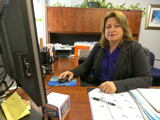 Sheri Wiley, Manager of Human Resources and Risk and Benefits Services for Marion County, is shown in office in Ocala, FL on Friday December 13, 2013. The county is paying out some six-figure worker's comp claims over the past year totaling almost $3M, but doing so has actually helped by possibly saving money, since the county's advisers say clearing a backlog of troubling cases has reduced teh liabilty.(Alan Youngblood/Ocala Star-Banner)2013