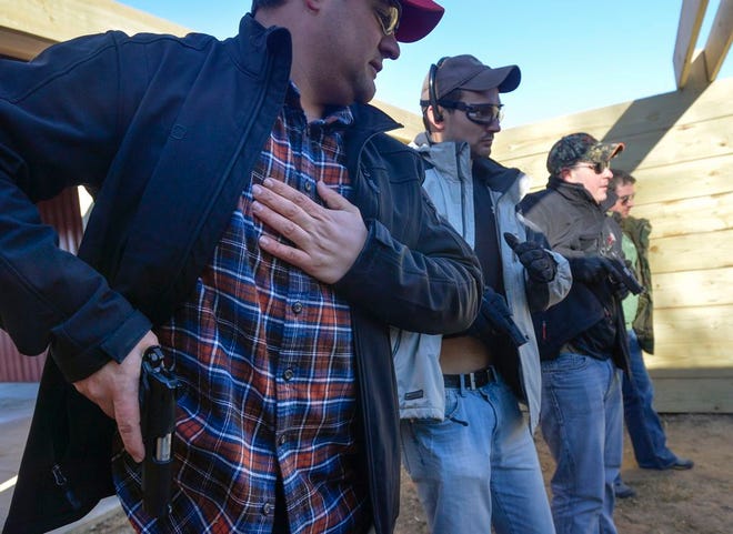FILE – Luke Gangloff practices pulling his concealed handgun with others in a class at the Deer Creek American Legion range.