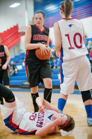 Peoria Heights' Adrianne Summers-Reynolds (23) was knocked over by Henry's Bradlie Crew (15) during the game Monday evening. Henry-Senachwine defeated Peoria Heights, 46-28.