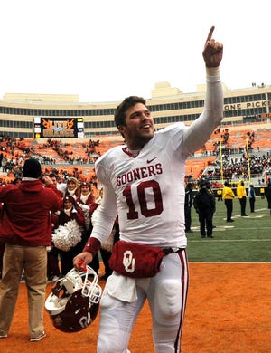 Oklahoma quarterback Blake Bell celebrates celebrates after their 34-24 win over Oklahoma State in an NCAA college football game in Stillwater, Okla., Saturday, Dec. 7, 2013.(AP Photo/Brody Schmidt)