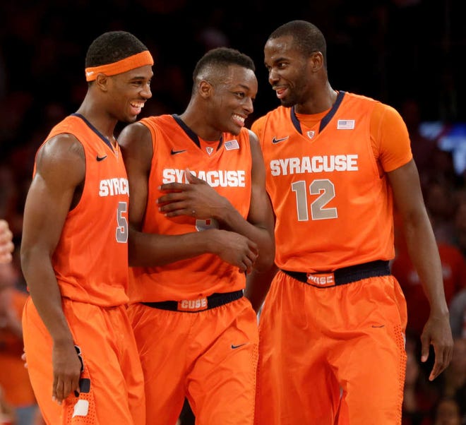 Syracuse's C.J. Fair, left, Jerami Grant and Baye Moussa Keita during the second half of an NCAA college basketball game Sunday, Dec. 15, 2013, in New York. Syracuse defeated St. John's 68-63. (AP Photo/Seth Wenig)