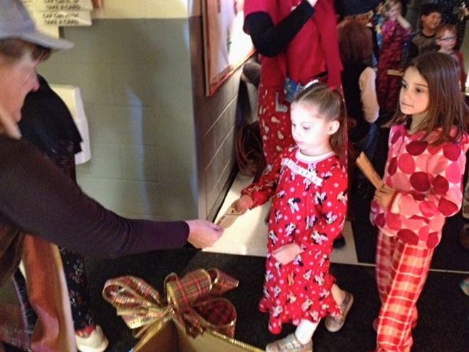 Courtesy photo

At the Early Childhood Learning Center in Barrington on Monday, Superintendent Gail Kushner hands students the tickets to “Polar Express,” as part of the annual literacy event at the center.
