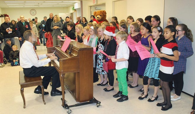 The Canandaigua Elementary School fifth-grade chorus, under the direction of Bill Mehls, sang holiday songs during the Tree of Lights ceremony at Thompson Health. Submitted photo.