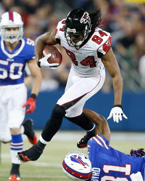 Atlanta Falcons wide receiver Roddy White (84) jumps over Buffalo Bills free safety Jairus Byrd (31) during the first half of an NFL football game on Sunday, Dec. 1, 2013, in Toronto. (AP Photo/Gary Wiepert)