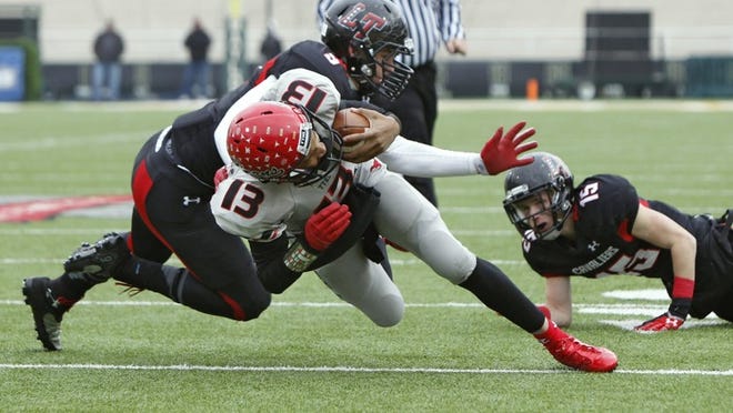 Lake Travis DE Michael Islava (9) stops Cedar Hill QB Justin McMillan (13) from scoring in the Division II 5A state football semifinal game at Floyd Casey Stadium in Waco. Lake Travis lost to Cedar Hill 19-10. Islava was selected to the AP all-state second team defense by The Associated Press.