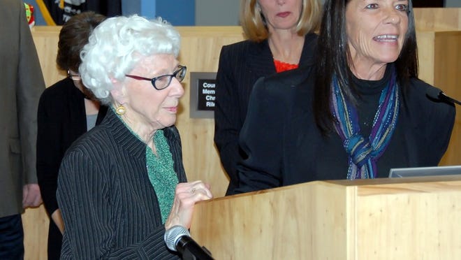 Longtime Lammes Candies’ employee Mildred Walston, left, at Austin City Council’s Dec. 12, 2013 meeting at which proclamation in her honor was approved. On right is Lammes Candies’ President Pam Teich. In back is Council Member Laura Morrison, sponsor of the proclamation.