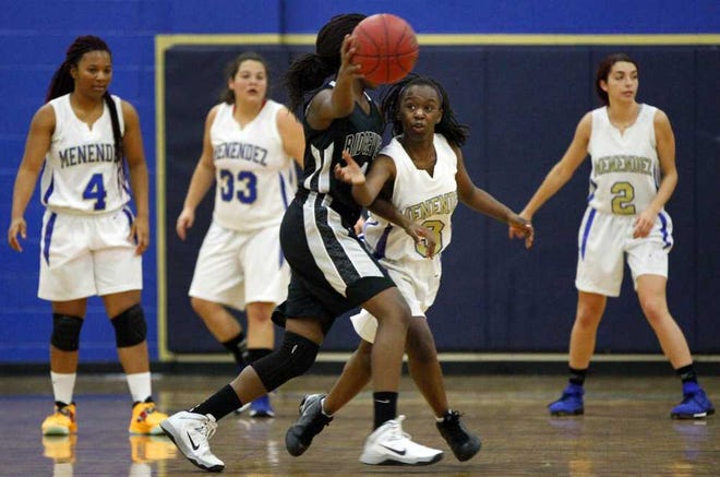 DARON.DEAN@STAUGUSTINE.COM Menendez' Almetric Tucker (3) reaches in to steal the ball from Ridgeview's Portia Williams (1) during high school basketball action at Pedro Menendez Wednesday night, December 18, 2013.