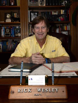 River pilot Capt. Rick Wesley sits at the desk in his Wilmington Island home.