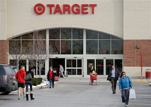 Shoppers leave a Target store in North Olmsted, Ohio Thursday, Dec. 19, 2013. Target says that about 40 million credit and debit card accounts may have been affected by a data breach that occurred just as the holiday shopping season shifted into high gear. (AP Photo/Mark Duncan)