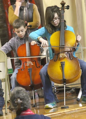Bailey Elementary School students Kenneth Krist and Lauren Jenkins play the cello during a concert by the Bailey String Program Thursday morning opening the TERRIFIC Kids assembly.
